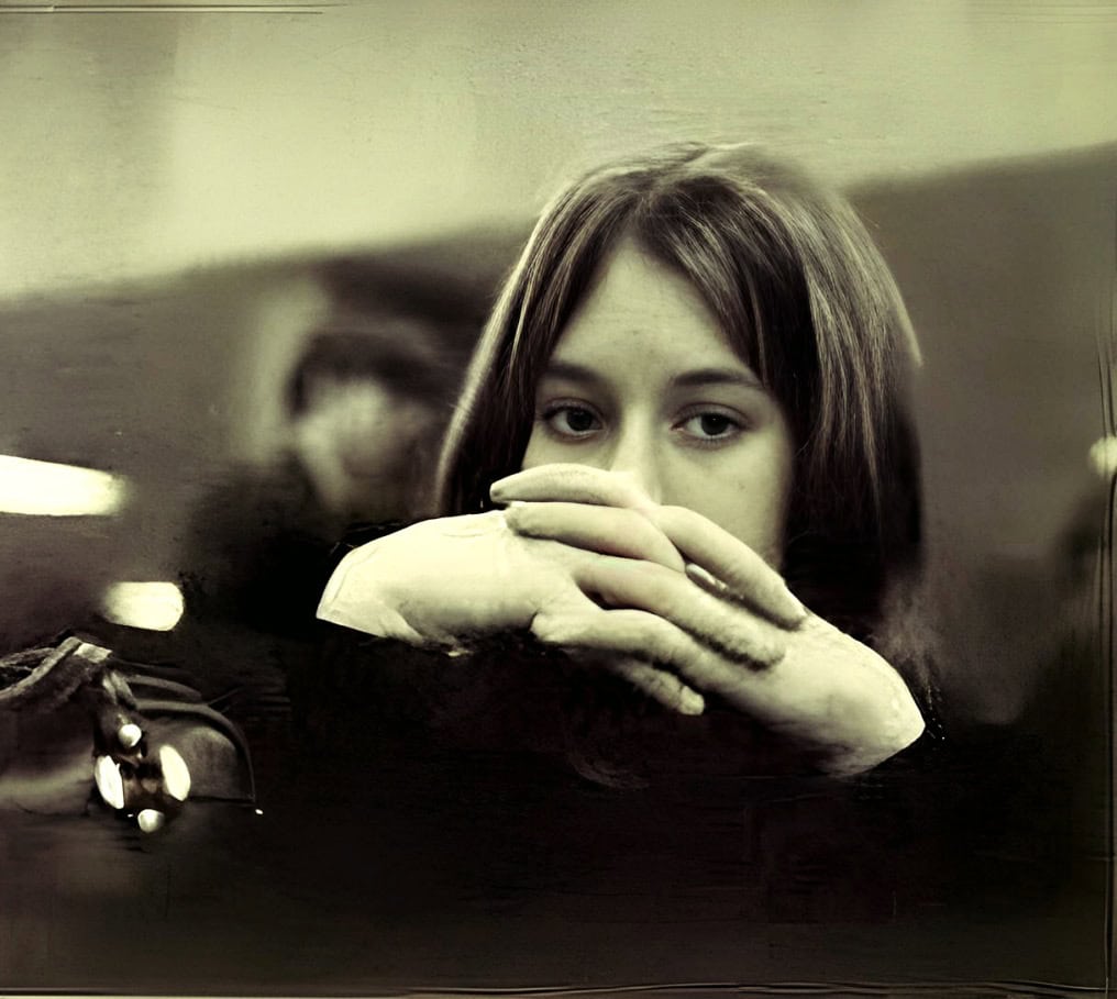 Young woman with hands covering mouth, reflecting introspection, in a vintage black and white style, emphasizing music, history, and sound archive themes for SEO.