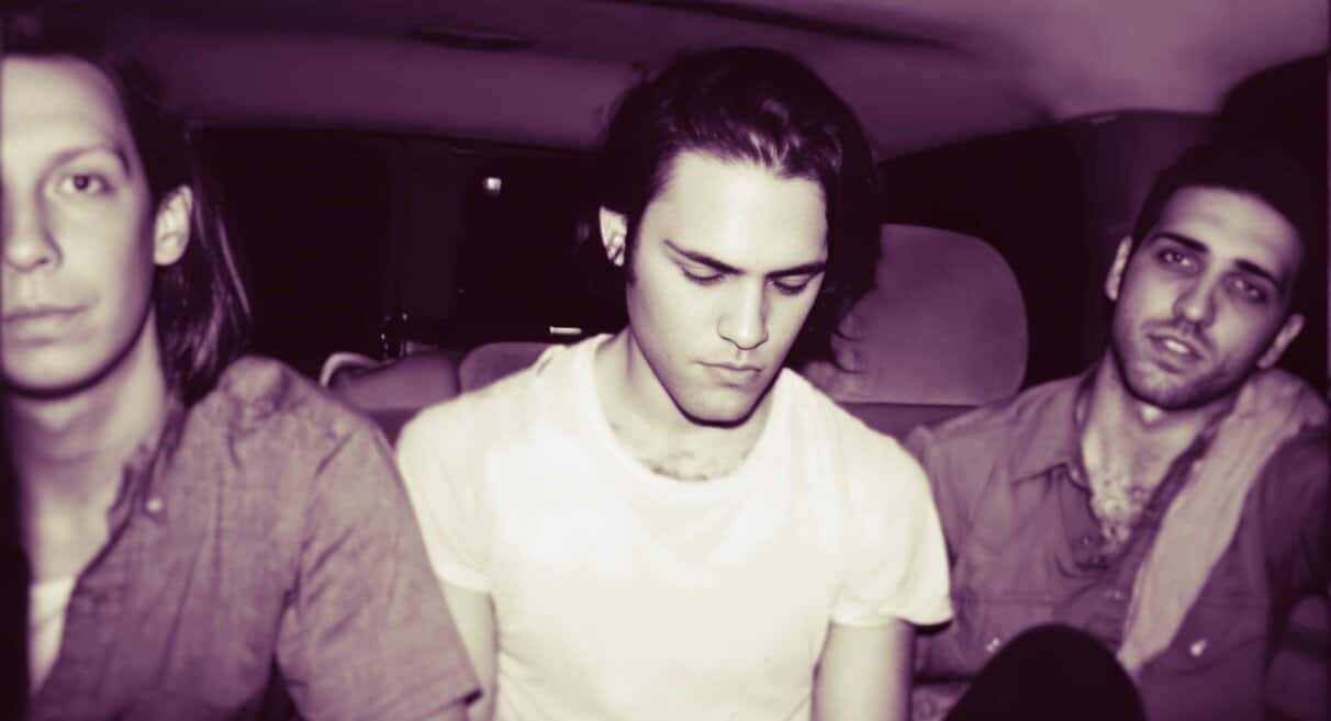 Vintage photo of The Smiths band members inside a vehicle, emphasizing the 1980s alternative rock music scene, with a focus on music history and cultural influence.