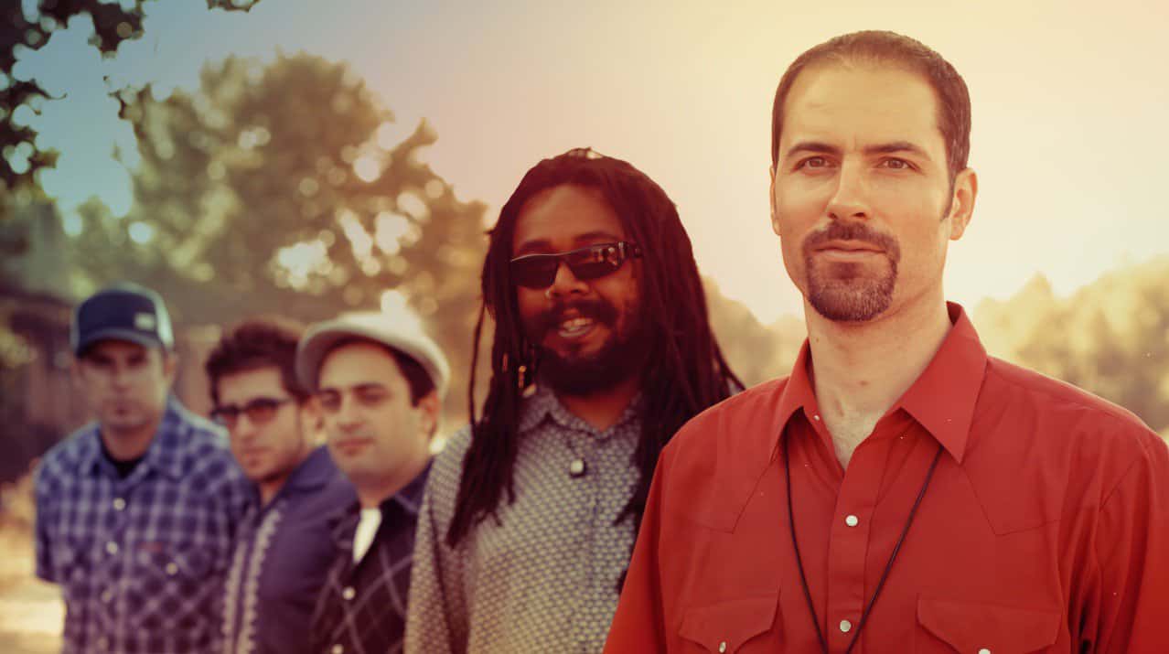 Vibrant outdoor scene featuring a diverse group of musicians with the sun setting behind them, exemplifying a sound archive of news, history, and music from Past Daily.