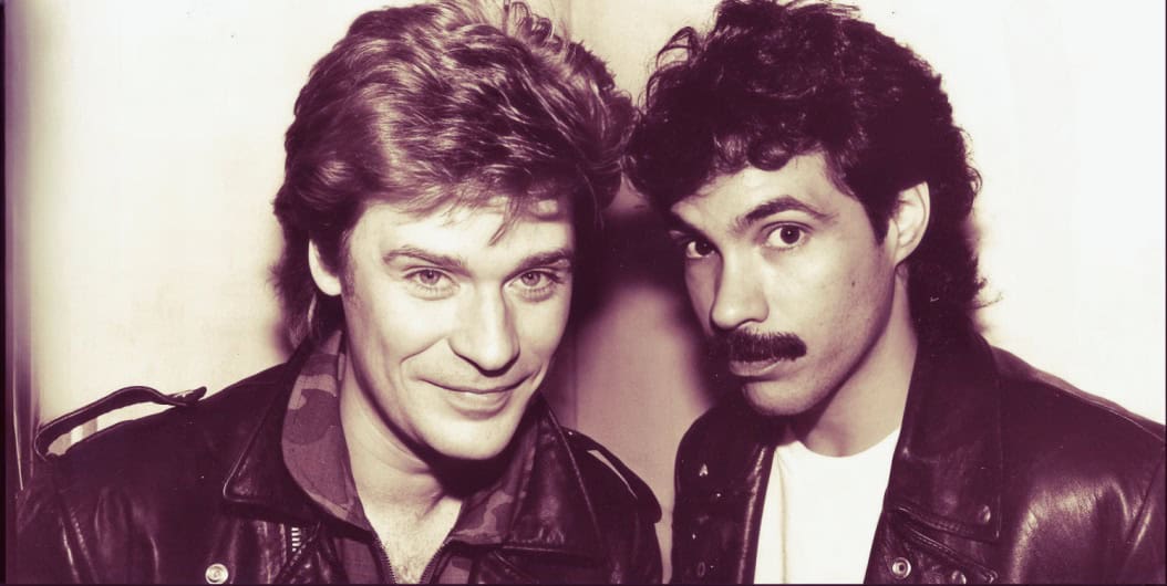 Vintage photo of iconic 1980s rock musicians David Bowie and Freddie Mercury, showcasing their legendary music careers and influence on rock and pop history.