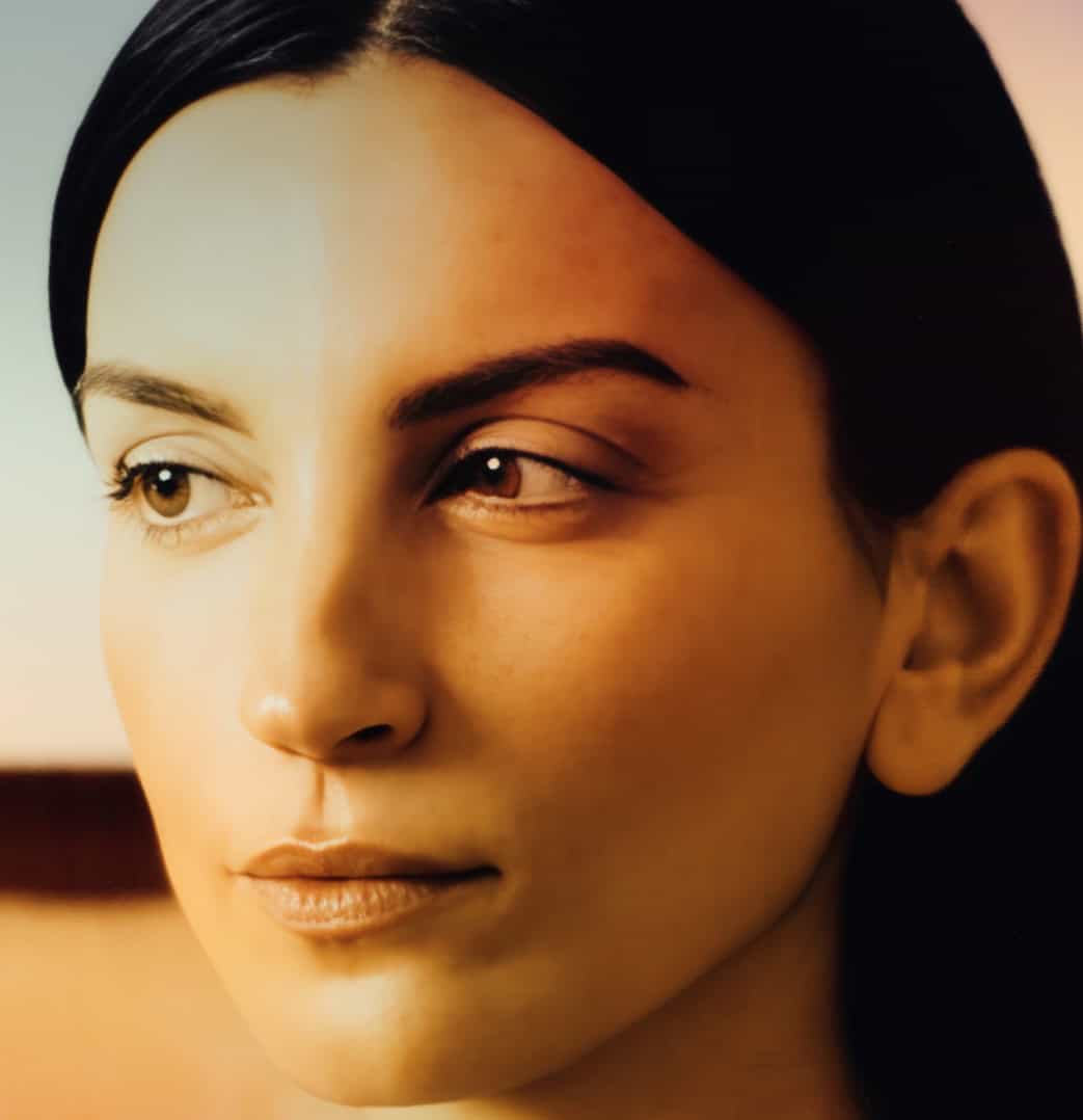 Vintage portrait of a woman with dark hair and flawless skin, representing classic beauty and elegance. Perfect for themes related to history, timeless style, and cultural art.