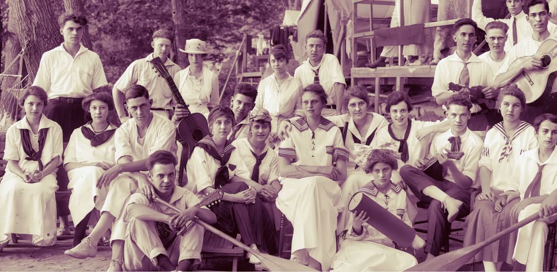 Past daily archive of historical news, music, and cultural photographs featuring a vintage group of children and teenagers in traditional attire.
