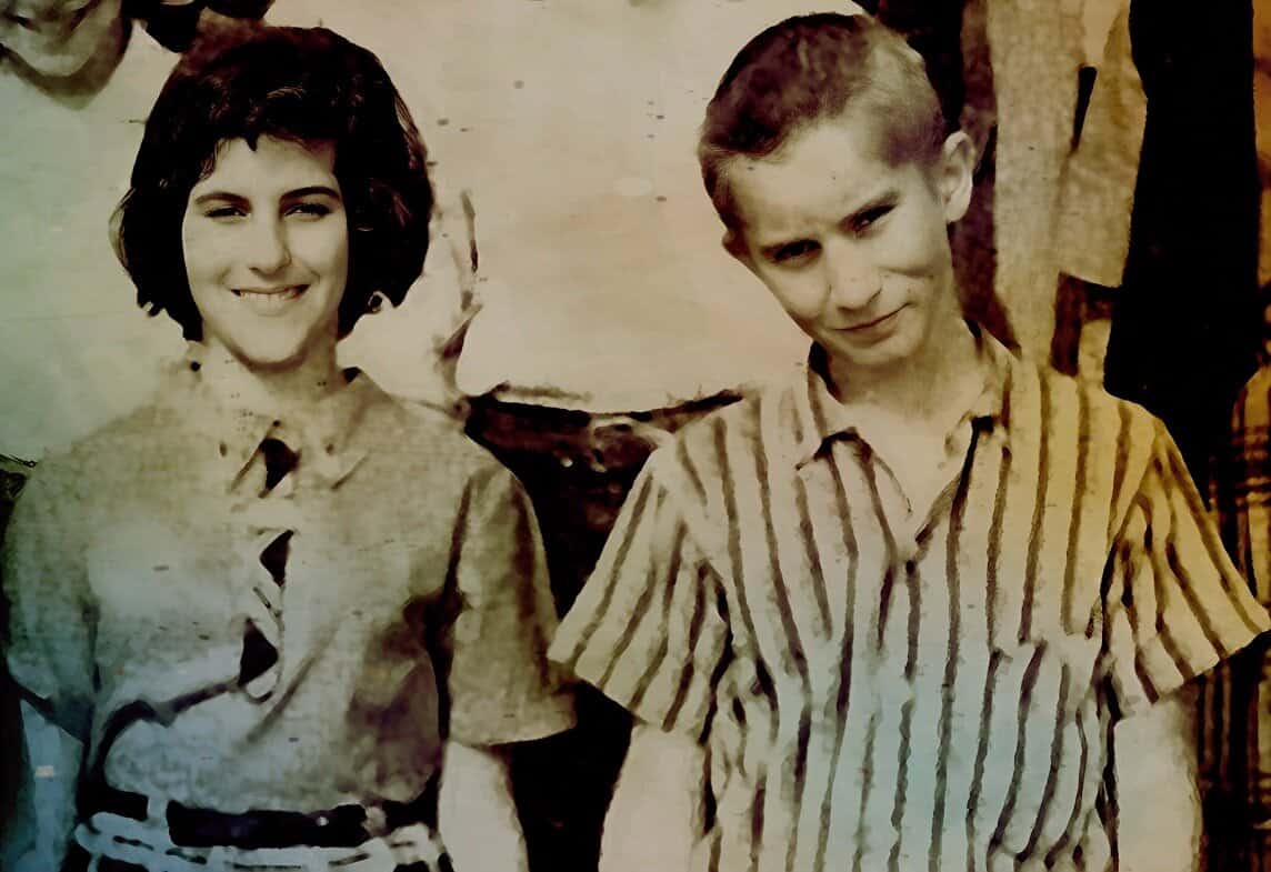Vintage black and white photo of a young woman and boy, from the 1950s or 1960s, reflecting nostalgia, childhood memories, and classic American history, perfect for archival news, music, and history visuals.