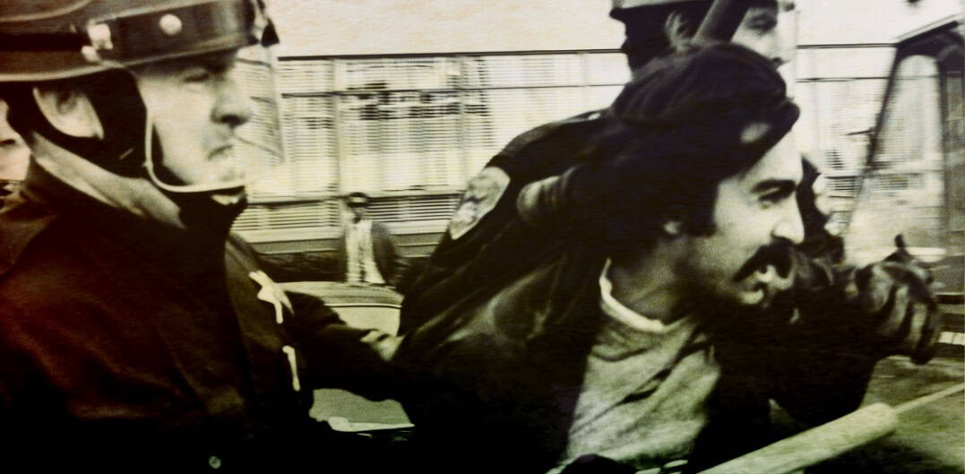 POLICE ARRESTING A PROTESTER ON THE STREET IN A HISTORIC NEWS EVENT New historical news footage showing police detaining a protester during a public demonstration.