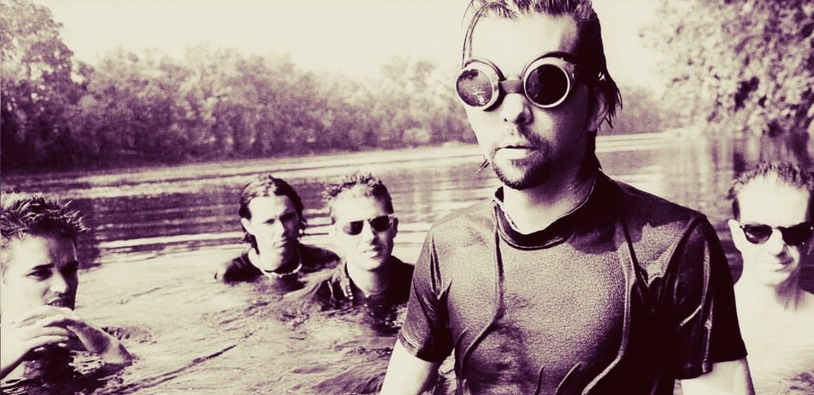 A group of young adults in sunglasses floating in a river, enjoying music and outdoor leisure, representing modern lifestyle and recreational activities.