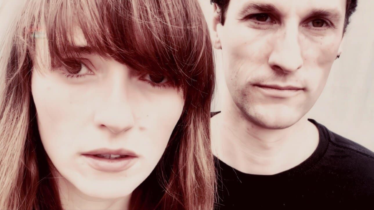Close-up of a young woman and a man, both with intense expressions, representing music, news, and history archives on Past Daily’s sound archive platform.