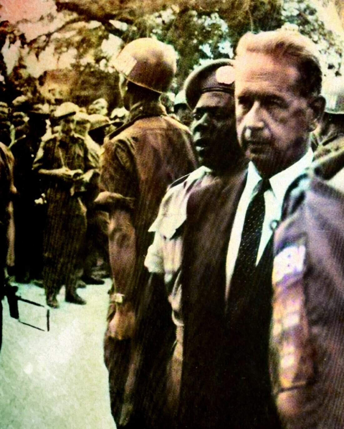 Russian soldiers and U.S. officer inspecting military personnel, historical black-and-white photo, Cold War era, military uniforms, historic news, vintage military scene, past daily news archive, history of armed forces, old military event, vintage military uniform photography.