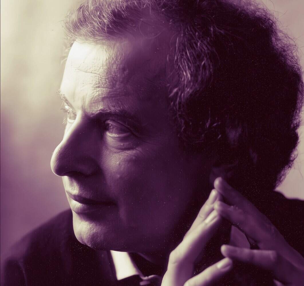 Vintage black and white portrait of a thoughtful woman with wavy hair, captured in a close-up profile shot, highlighting her contemplative expression and graceful hand gesture.