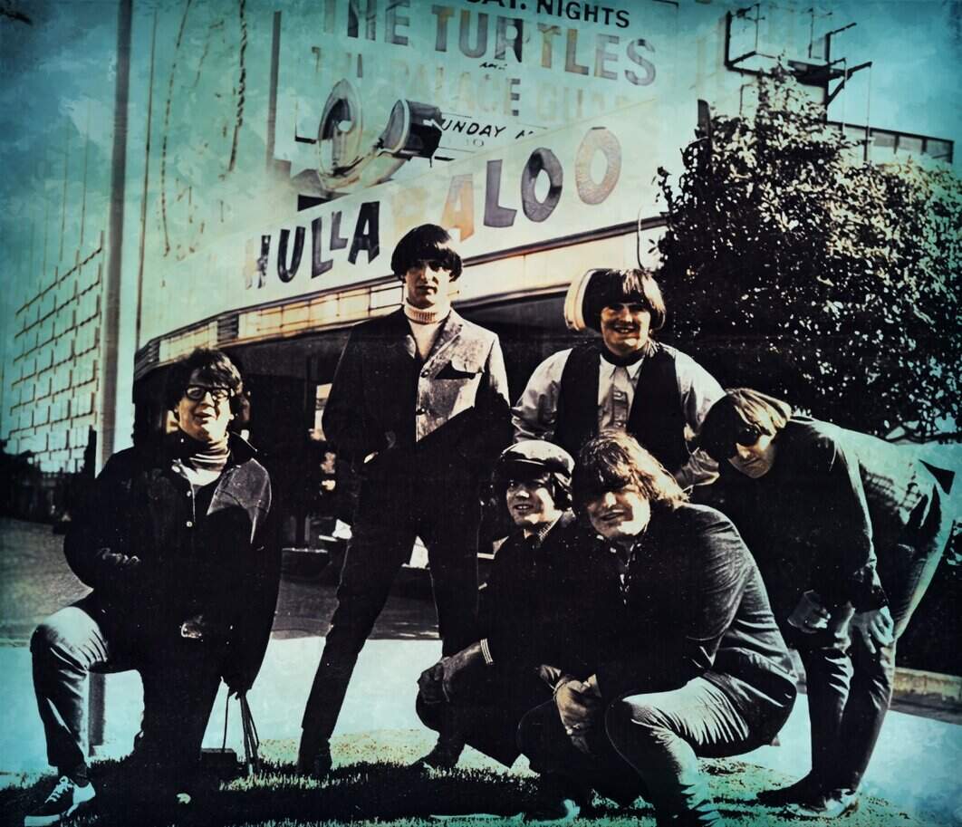 Vintage black-and-white photo of a band posing in front of a theater marquee with retro style; likely from the 1960s or 1970s, evoking mid-century music history and cultural nostalgia.