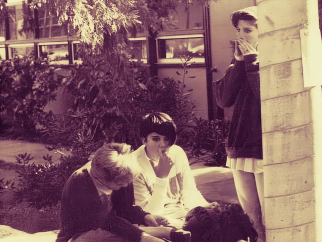 People reading and listening to news outdoors, vintage black and white photo, Past Daily: A Sound Archive of News, History And Music, peaceful scene featuring children enjoying music and stories in a garden setting, nostalgic atmosphere.