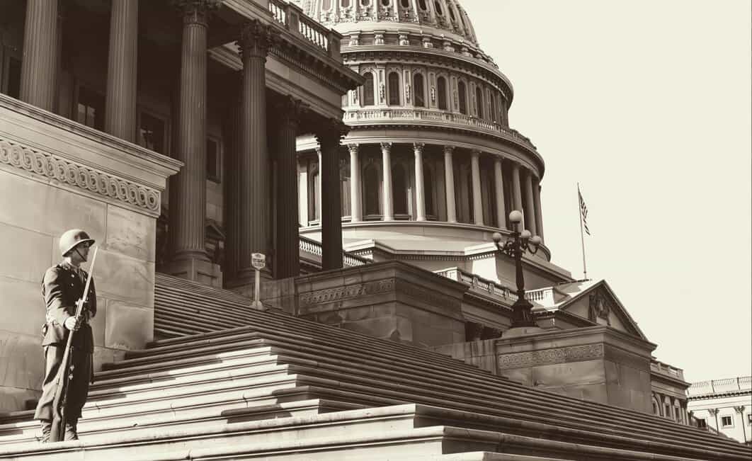 U.S. Capitol building with a guard at the entrance, showcasing historic architecture and national significance. Perfect for news, history, and political archives related to American government.
