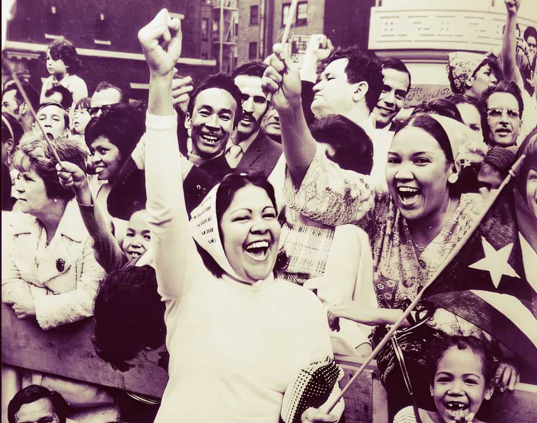 People celebrating a historic event, holding flags and cheering in a lively outdoor gathering, capturing a moment of joy and unity during a significant cultural or political rally.