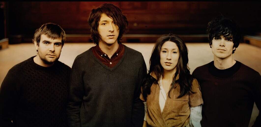 A live band of four diverse musicians standing in a recording studio, showcasing their musical talent and style. The image highlights the connection between music, history, and cultural storytelling found in Past Daily's archives.