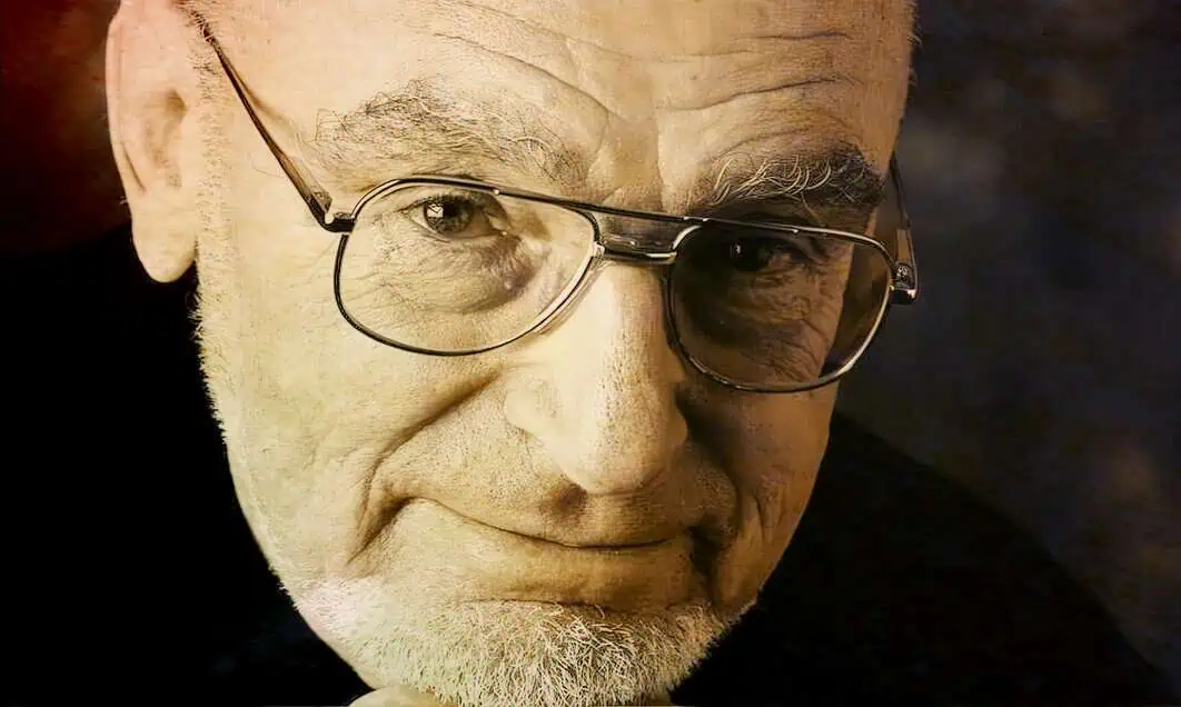 Famous elderly man with glasses and white beard, close-up portrait, nostalgic and timeless, representative of history and music archives.