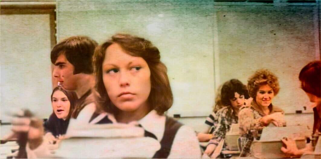 Students sitting in a classroom listening to a lecture, focusing on a girl with brown hair at the center, vintage classroom setting, 1970s school scene, nostalgic educational environment.