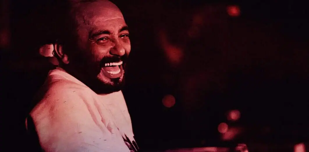 Vibrant image of a joyful man with a big smile, capturing the lively spirit of music and celebration, ideal for representing Past Daily's archive of news, history, and music.